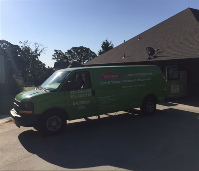 SERVPRO vehicle parked in front of structure. 