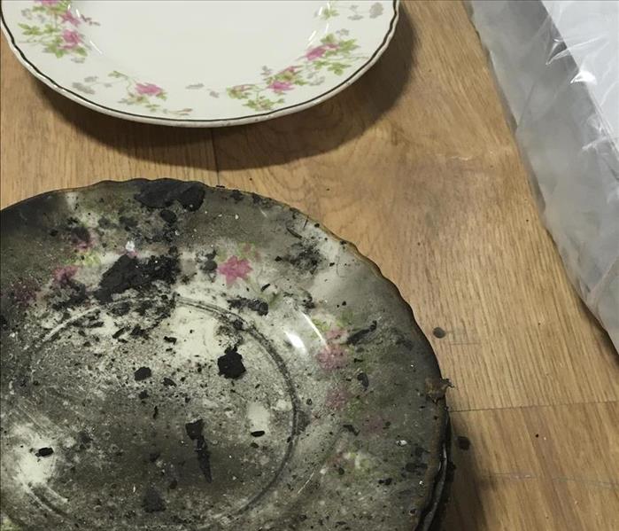 Two plates before and after they had been cleaned from fire damage.