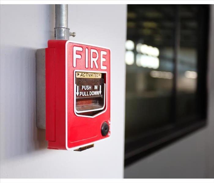 Fire alarm switch on the factory wall.