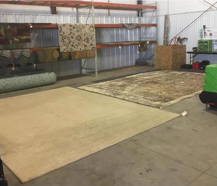 four rugs in a warehouse